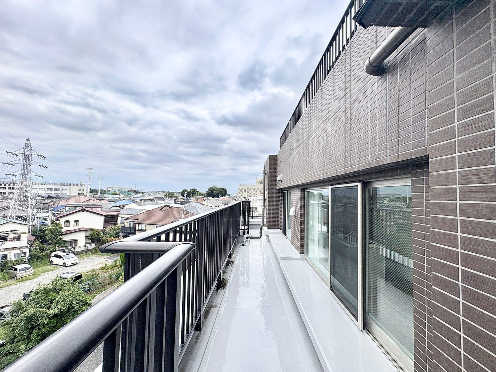 住宅地の屋根並みを見下ろす、細長い空の縁側